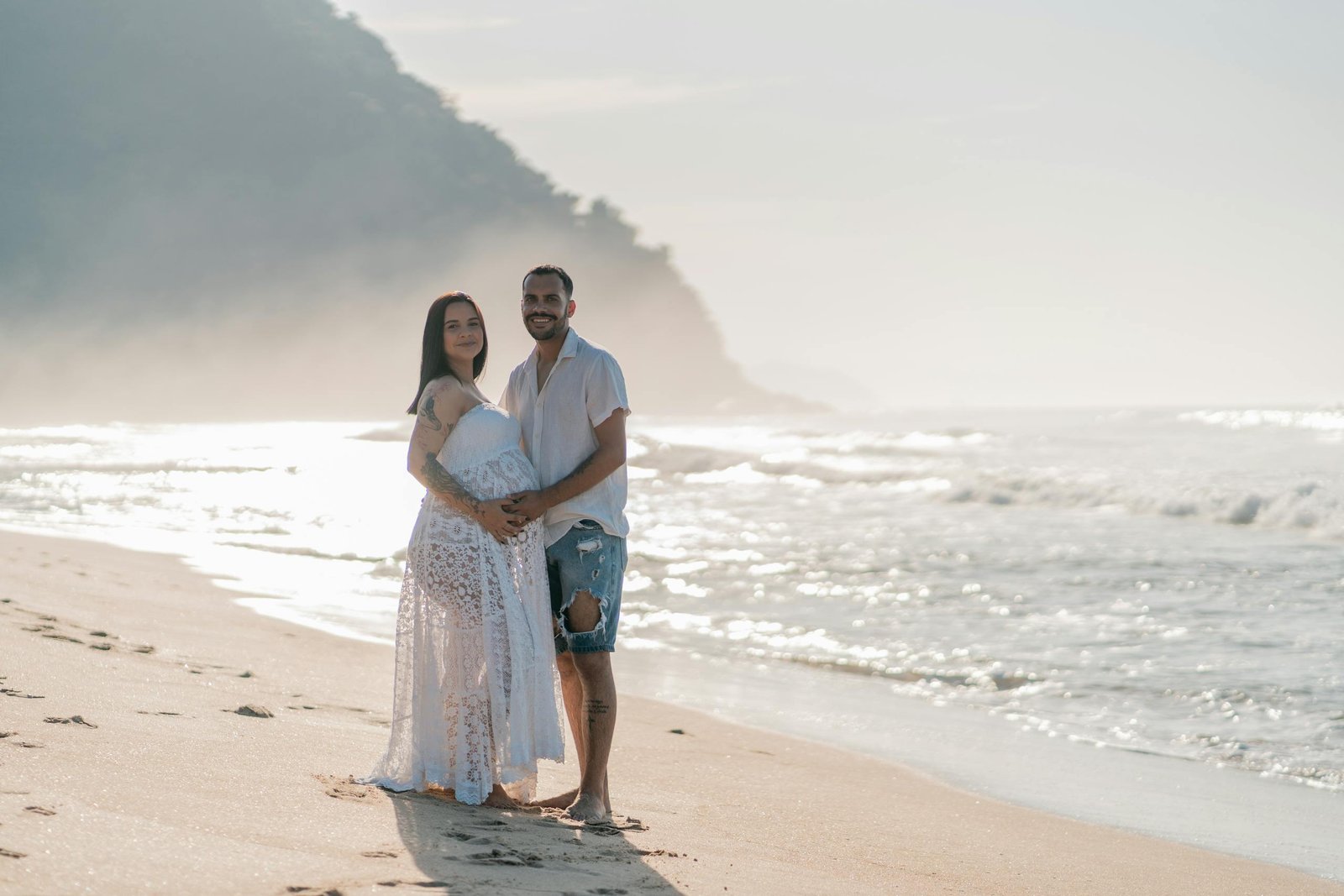 Couple enjoying a peaceful moment on a picturesque beach. Perfect for lifestyle and travel themes.